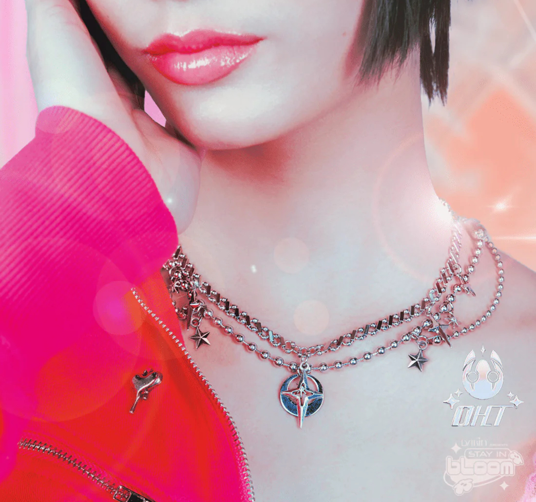 Close up of sliver necklace on person's neck.