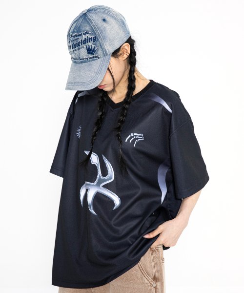 Girl wearing denim cap and jersey t-shirt with chrome accents.